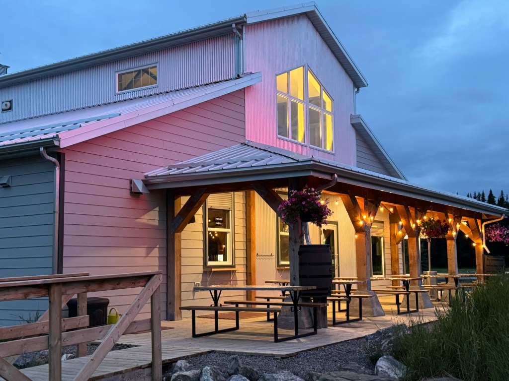Miner's Cafe in Nordegg, Alberta with its patio illuminated on a summer evening